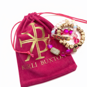 Custom drawstring jewellery pouch in velvet and linen fabric with gold foil logo for necklace and ring packaging.
