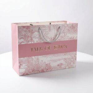 White 250gsm cardstock paper bag with custom gold debossed logo, matte lamination, and long shoulder straps.