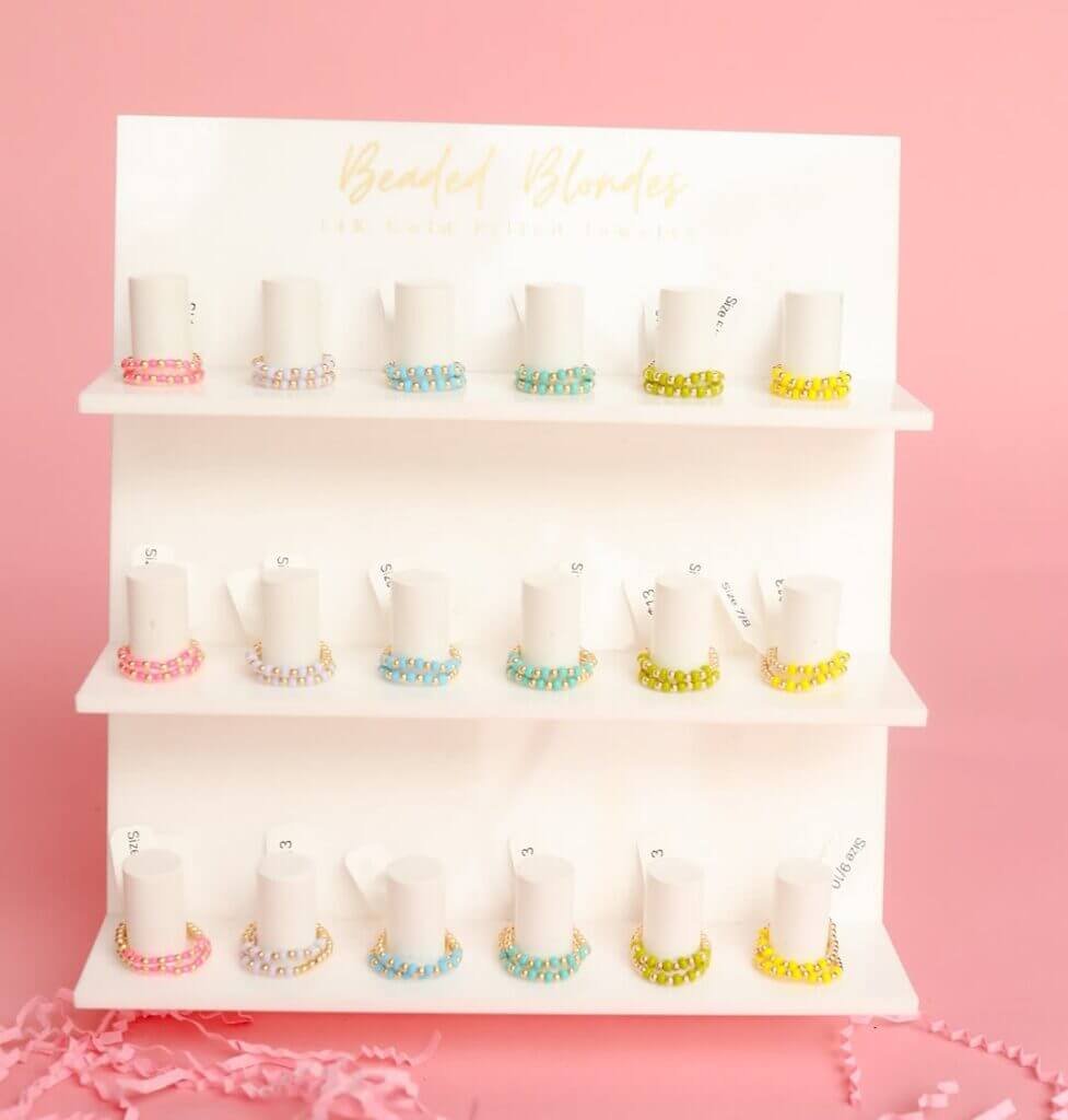3-tier white acrylic ring display stand with 18 slots and custom logo for retail jewelry counters.